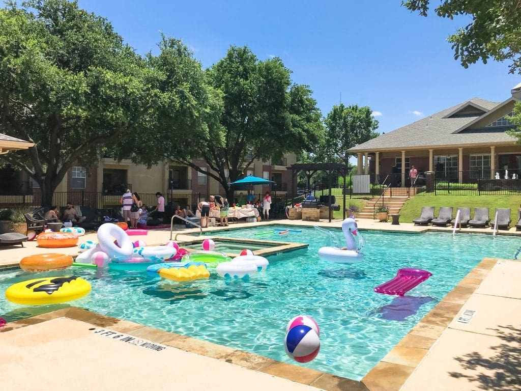 DALLAS, TX, US-June 15, 2019: Pool party at apartment building complex in suburban Dallas, Texas, America. Summertime event for resident with foods and games for families, kids