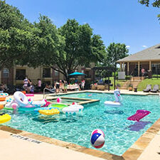 DALLAS, TX, US-June 15, 2019: Pool party at apartment building complex in suburban Dallas, Texas, America. Summertime event for resident with foods and games for families, kids